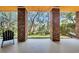 Covered patio featuring brick columns and views of the landscaped yard with hammock at 92 High Hammock Way, Pawleys Island, SC 29585