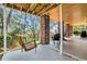 Spacious covered patio has chairs, a swing, brick columns and a wood ceiling at 92 High Hammock Way, Pawleys Island, SC 29585