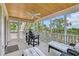 Screened porch with white ceiling fan, relaxing furniture, and peaceful neighborhood views at 92 High Hammock Way, Pawleys Island, SC 29585