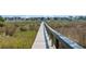 Long wooden walkway leading to waterfront houses surrounded by tall marsh grass at 92 High Hammock Way, Pawleys Island, SC 29585