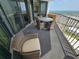 Comfortable balcony featuring a dining table and chairs with stunning views of the surrounding area at 9650 Shore Dr. # 2207, Myrtle Beach, SC 29572