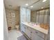 Light and airy bathroom with a modern vanity and decorative wallpaper at 9650 Shore Dr. # 2207, Myrtle Beach, SC 29572