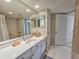 Bright bathroom with neutral wallpaper and a white vanity at 9650 Shore Dr. # 2207, Myrtle Beach, SC 29572