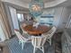 Dining room featuring a unique light fixture, ocean-themed artwork, and seating for six at 9650 Shore Dr. # 2207, Myrtle Beach, SC 29572