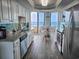 Bright kitchen featuring white cabinets, stainless steel appliances, granite countertops, and a breakfast nook with an ocean view at 9650 Shore Dr. # 2207, Myrtle Beach, SC 29572