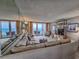 Open living room with a large comfortable sectional, mirrored wall, and a view of the ocean at 9650 Shore Dr. # 2207, Myrtle Beach, SC 29572