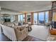 Spacious living room with an open floor plan, large windows, and access to a scenic balcony at 9650 Shore Dr. # 2207, Myrtle Beach, SC 29572