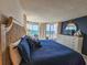 A calming bedroom with a navy palette, complete with balcony and ocean view at 9650 Shore Dr. # 2207, Myrtle Beach, SC 29572