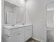 Bathroom featuring dual sinks, a large framed mirror, and luxury vinyl flooring at 1000 Sentinel Ct., Little River, SC 29566