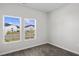 Bedroom featuring two windows, luxury vinyl flooring and bright neutral walls at 1000 Sentinel Ct., Little River, SC 29566