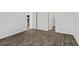 Bedroom showcasing luxury vinyl flooring, open doorways, and access to the kitchen at 1000 Sentinel Ct., Little River, SC 29566