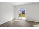 Living room with vinyl floors and a glass sliding door to the back yard at 1000 Sentinel Ct., Little River, SC 29566