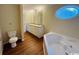 Bathroom featuring a double sink vanity, decorative window, and a soaking tub at 1000 Weldon Ln., Conway, SC 29526