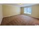 Neutral bedroom offering plush carpet, neutral walls, and a large window for natural light at 1000 Weldon Ln., Conway, SC 29526