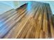 Beautiful new hardwood flooring in a hallway setting, reflecting light and leading to a doorway at 1000 Weldon Ln., Conway, SC 29526