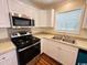 Bright kitchen featuring stainless steel appliances, white cabinetry, and natural light from the window at 1000 Weldon Ln., Conway, SC 29526