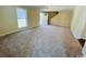 Inviting living room featuring tan carpet flooring, ample natural light, and neutral paint at 1000 Weldon Ln., Conway, SC 29526