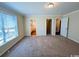 Bright main bedroom featuring plush carpet, neutral walls, and multiple closets for optimal storage at 1000 Weldon Ln., Conway, SC 29526