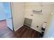 Small storage area with shelves, utility connections, and wood-look flooring at 1000 Weldon Ln., Conway, SC 29526