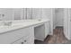 Modern bathroom featuring double sinks with a vanity, with stylish wood-look flooring and a walk-in closet at 1008 Sentinel Ct., Little River, SC 29566