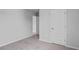 Neutral bedroom with light gray walls, neutral carpet, and white doors leading to other rooms at 1008 Sentinel Ct., Little River, SC 29566