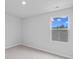 Light, airy bedroom features neutral carpet, light gray walls, and a window with a view of trees at 1008 Sentinel Ct., Little River, SC 29566
