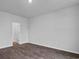 Bright bedroom with modern dark wood flooring and neutral paint, ready for personalization at 1008 Sentinel Ct., Little River, SC 29566