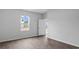 Bright bedroom featuring modern flooring, neutral paint, and a window, providing a clean and welcoming space at 1008 Sentinel Ct., Little River, SC 29566
