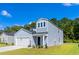 Charming two-story home featuring a light blue exterior, attached garage, and manicured front yard at 1008 Sentinel Ct., Little River, SC 29566