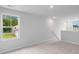 Bright living room featuring neutral carpeting, walls, and large windows, creating a serene and adaptable space at 1008 Sentinel Ct., Little River, SC 29566