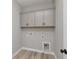 Laundry room with overhead cabinets and utility connections at 1075 Laconic Dr., Myrtle Beach, SC 29588