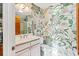 Bathroom featuring floral wallpaper, shower, and vanity with white cabinets and countertops at 12 Jerry Ct., Pawleys Island, SC 29585