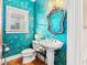Powder room featuring turquoise walls with bird print wallpaper, pedestal sink, and white window at 12 Jerry Ct., Pawleys Island, SC 29585