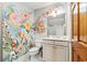 Charming bathroom with custom floral mural on walls, vanity with white cabinets, and tiled floors at 12 Jerry Ct., Pawleys Island, SC 29585