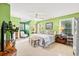 Inviting bedroom features light green walls, natural light, ceiling fan, and plush neutral carpet at 12 Jerry Ct., Pawleys Island, SC 29585