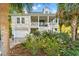 Inviting two-story home featuring a spacious front porch, beautiful landscaping, and a convenient garage at 12 Jerry Ct., Pawleys Island, SC 29585