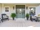 Inviting front porch featuring a statement door, planters, and comfortable seating for relaxing outdoors at 12 Jerry Ct., Pawleys Island, SC 29585