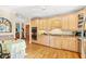 Bright eat-in kitchen features custom cabinetry, stainless steel appliances, and hardwood floors at 12 Jerry Ct., Pawleys Island, SC 29585