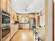 Bright kitchen featuring stainless steel appliances, custom cabinets, and hardwood floors at 12 Jerry Ct., Pawleys Island, SC 29585