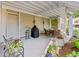 Cozy covered patio with seating area, grill and garden accessories creating a relaxing outdoor space at 12 Jerry Ct., Pawleys Island, SC 29585