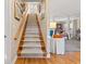 Grand staircase with wood railing and carpet runner leads to the upper level at 12 Jerry Ct., Pawleys Island, SC 29585