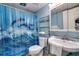 Cozy bathroom with dolphin shower curtain, sink, toilet and open shelving at 1210 N Waccamaw Dr. # 602, Murrells Inlet, SC 29576