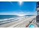 Beautiful beach view and oceanfront pool from the balcony with lounge chairs available for relaxing at 1210 N Waccamaw Dr. # 602, Murrells Inlet, SC 29576