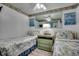 Inviting bedroom featuring two twin beds, beach-themed decor and matching nightstand at 1210 N Waccamaw Dr. # 602, Murrells Inlet, SC 29576