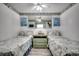 Inviting bedroom featuring two twin beds and beach-themed decor at 1210 N Waccamaw Dr. # 602, Murrells Inlet, SC 29576