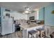 Bright kitchen featuring white cabinets, modern appliances, and a breakfast bar with stools at 1210 N Waccamaw Dr. # 602, Murrells Inlet, SC 29576