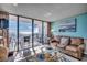 Living room with a comfortable couch and a view of the beach from the balcony at 1210 N Waccamaw Dr. # 602, Murrells Inlet, SC 29576