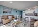 Living room and kitchen area with updated appliances, comfortable couch and dining room table at 1210 N Waccamaw Dr. # 602, Murrells Inlet, SC 29576