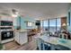 Open concept living room, dining room, and kitchen with ocean views from the balcony at 1210 N Waccamaw Dr. # 602, Murrells Inlet, SC 29576