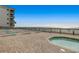 Inviting patio space with lounge chairs for relaxing near the ocean at 1210 N Waccamaw Dr. # 602, Murrells Inlet, SC 29576
